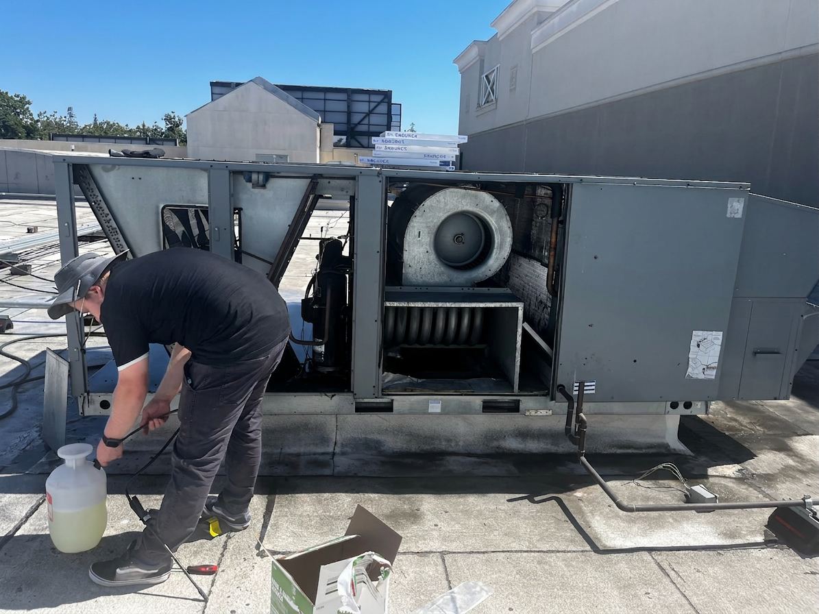 ABC Service technician performing rooftop AC maintenance on a packaged unit in the Bay Area.