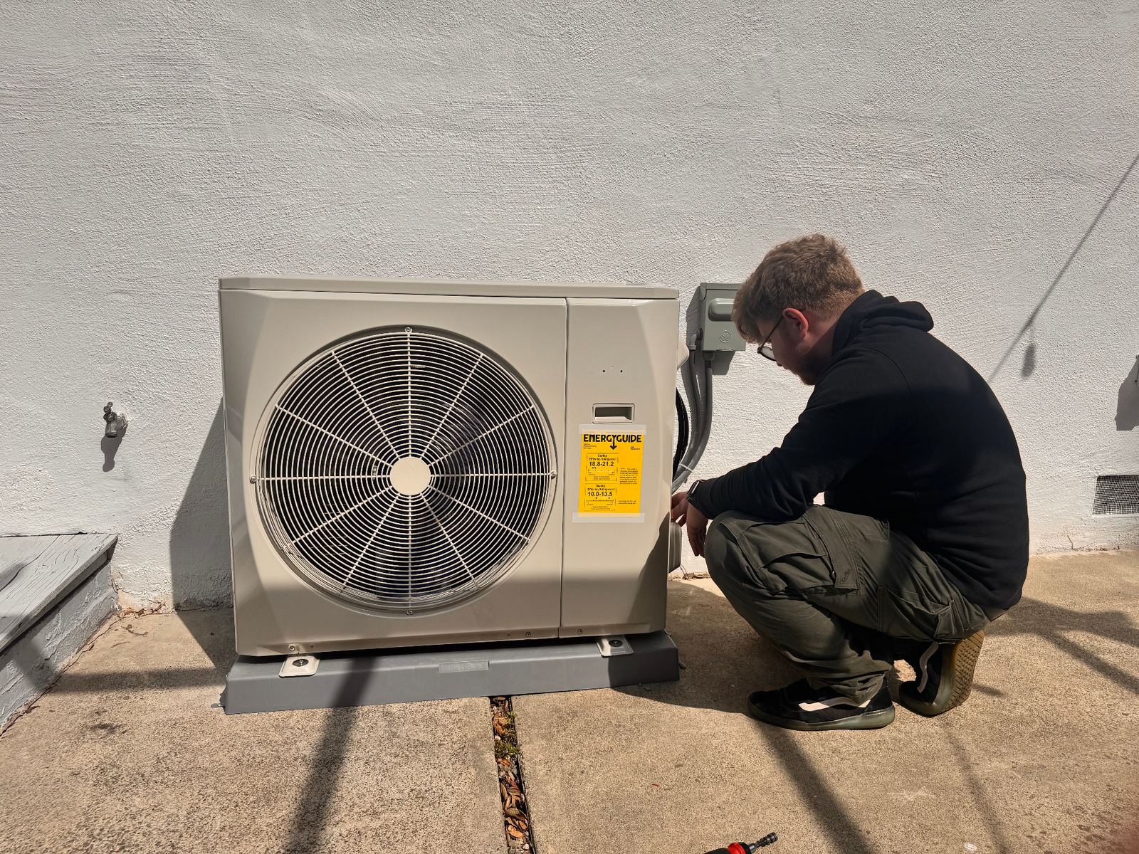 ABC Service technician diagnosing an outdoor AC condenser at a Bay Area home.