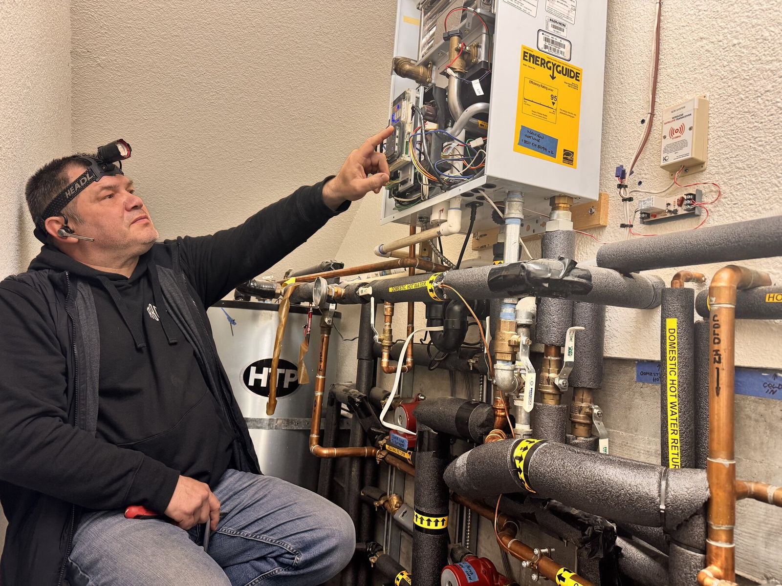 ABC Service technician running combustion and pressure diagnostics on a hydronic boiler system in a Bay Area mechanical room.