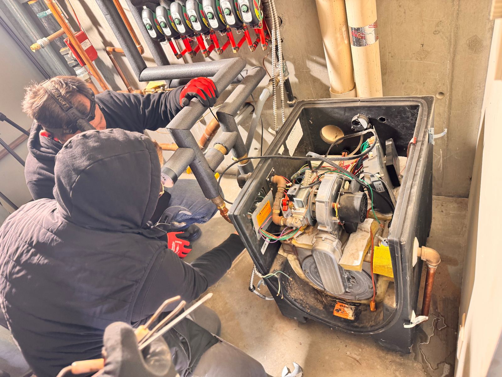ABC Service technicians replacing an aging cast-iron boiler and rebuilding the hydronic near-boiler piping in a Bay Area mechanical room.