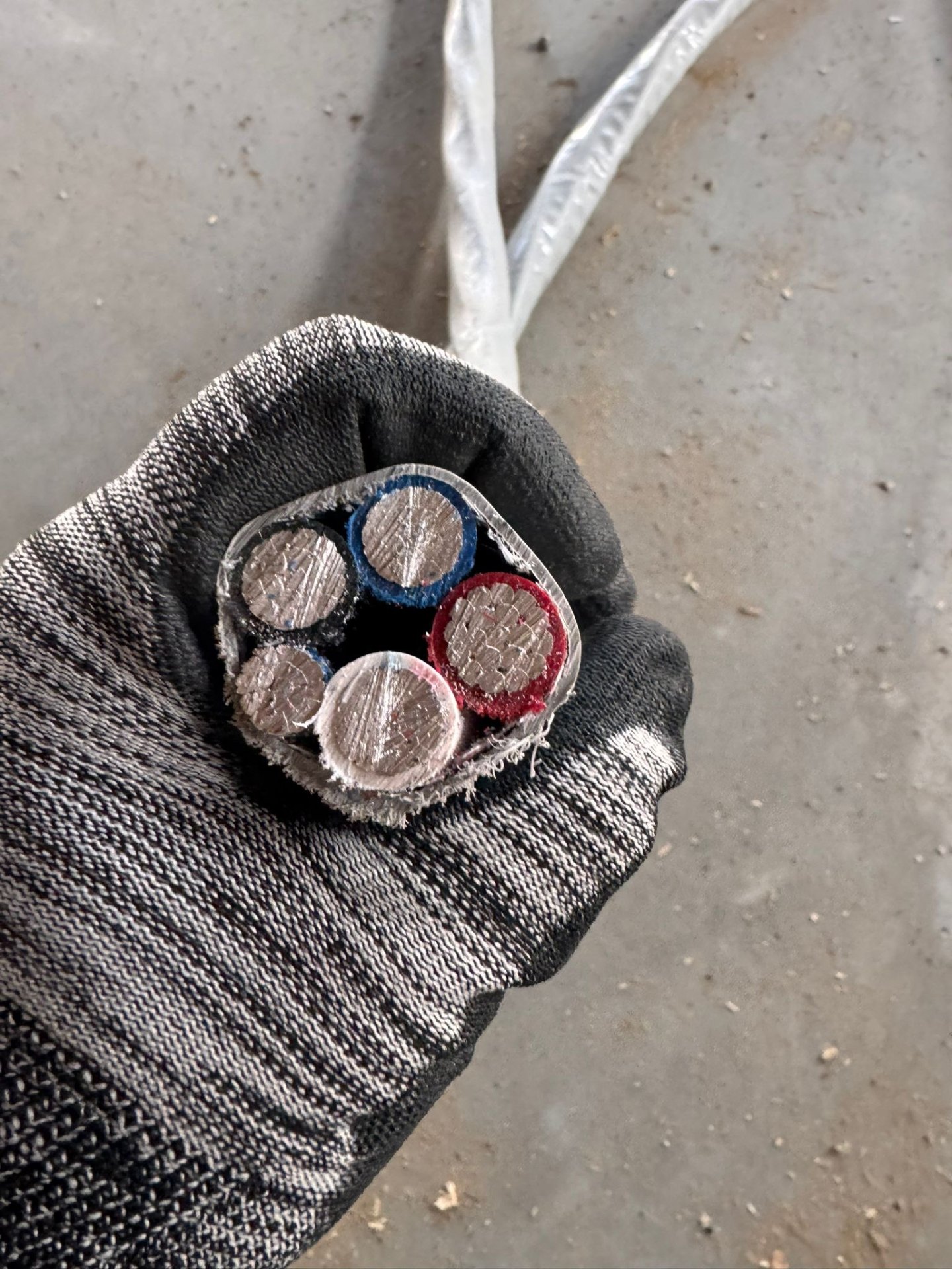 Cross-section of a large multi-conductor commercial feeder cable held by an ABC Service electrician on a Bay Area job site