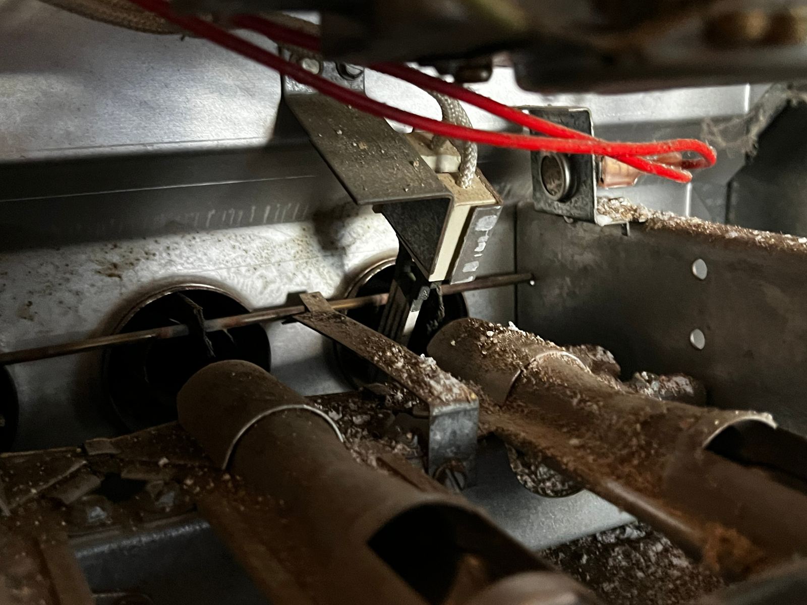 Close-up of a dust-laden furnace burner assembly during maintenance service.