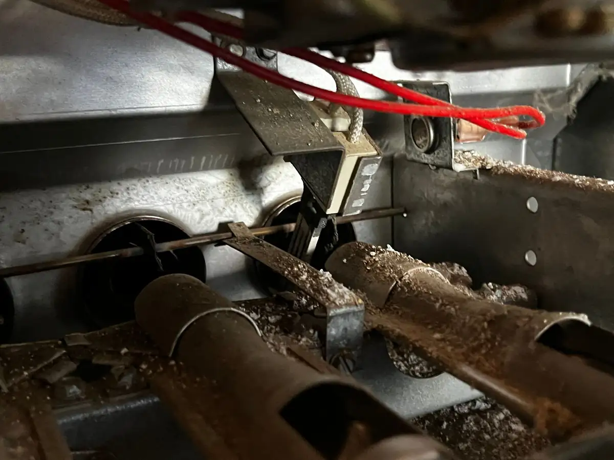 Close-up of a dust-laden furnace burner assembly during maintenance service.