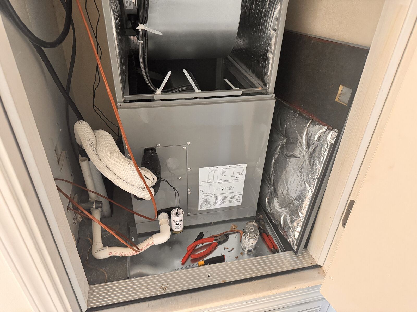 Modern heat pump air handler and refrigerant line-set neatly installed in a Bay Area mechanical closet during an ABC Service furnace-to-heat-pump retrofit.