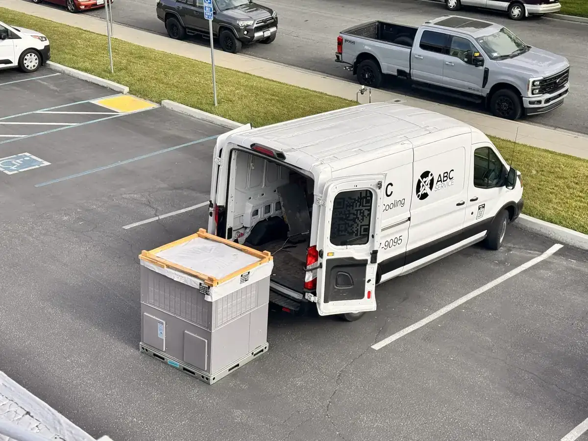 ABC Service technician installing a commercial rooftop packaged HVAC unit.