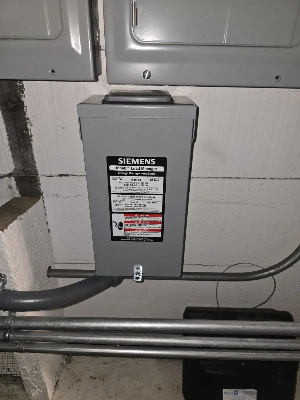 Siemens Inhab smart load manager mounted alongside the main service equipment with clean EMT conduit runs during an ABC Service sub-panel installation in the Bay Area.