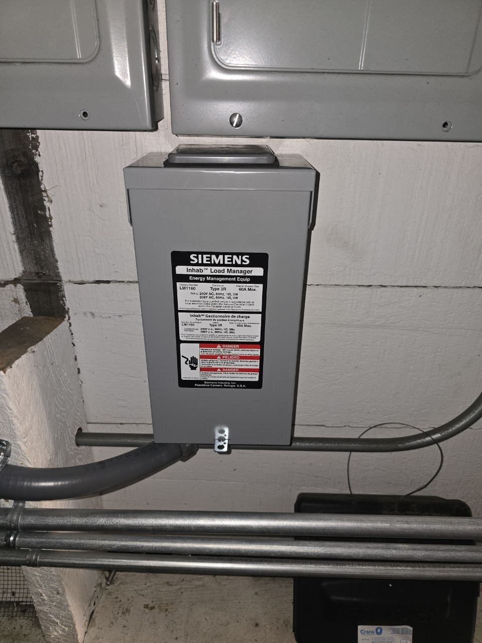 Siemens Inhab smart load manager mounted alongside the main service equipment with clean EMT conduit runs during an ABC Service sub-panel installation in the Bay Area.